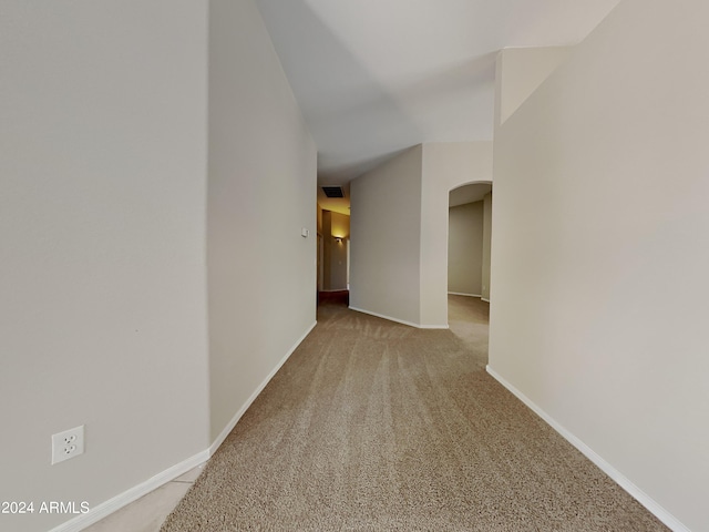 hallway featuring light colored carpet