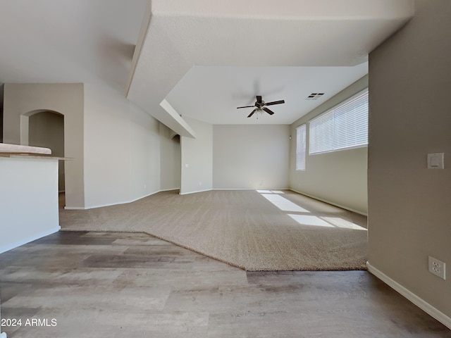 unfurnished living room featuring ceiling fan