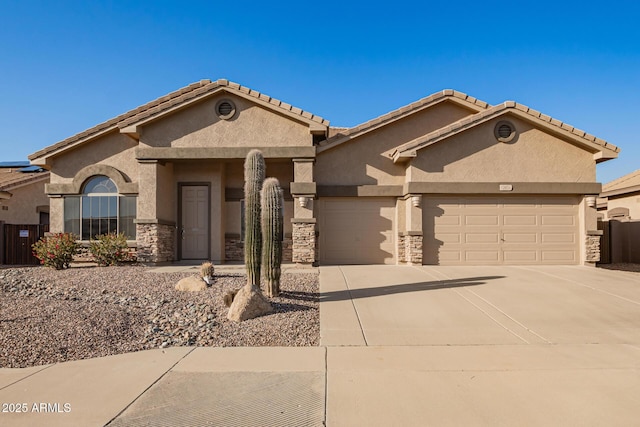 view of front of house featuring a garage, stone siding, driveway, and stucco siding