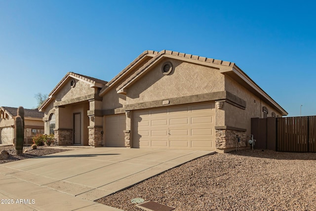 view of front facade featuring stone siding, stucco siding, concrete driveway, and a garage