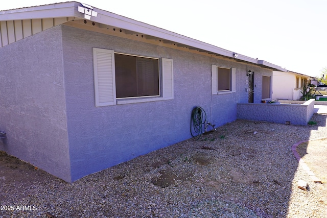 view of side of property with stucco siding