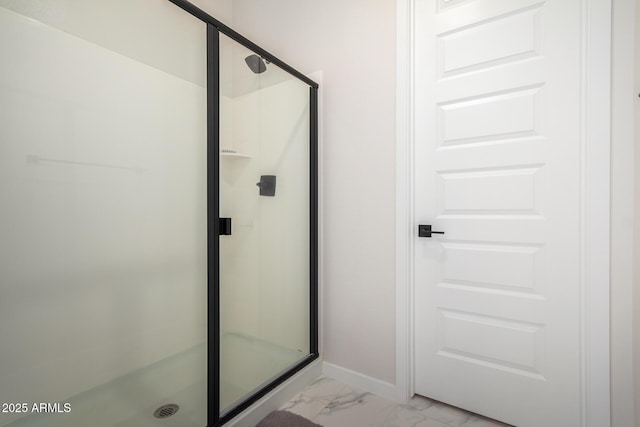 bathroom with a shower with door