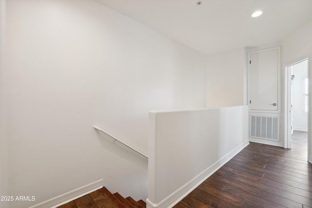 hallway with dark hardwood / wood-style floors