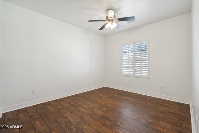 empty room with dark wood-type flooring and ceiling fan