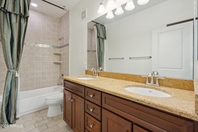 full bathroom featuring shower / tub combo with curtain, vanity, and toilet