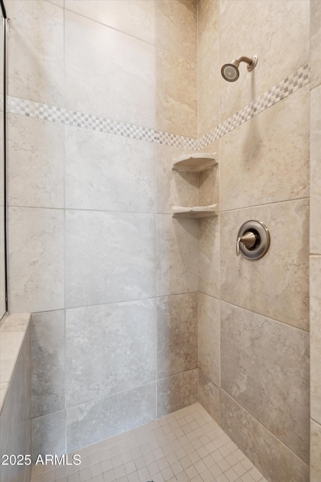 bathroom with a tile shower