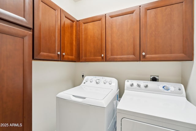 washroom with independent washer and dryer and cabinets