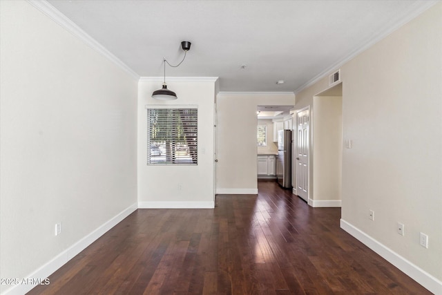 empty room with ornamental molding and dark hardwood / wood-style floors