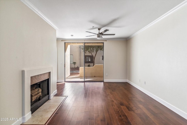 unfurnished living room featuring hardwood / wood-style floors, ornamental molding, a tile fireplace, and ceiling fan