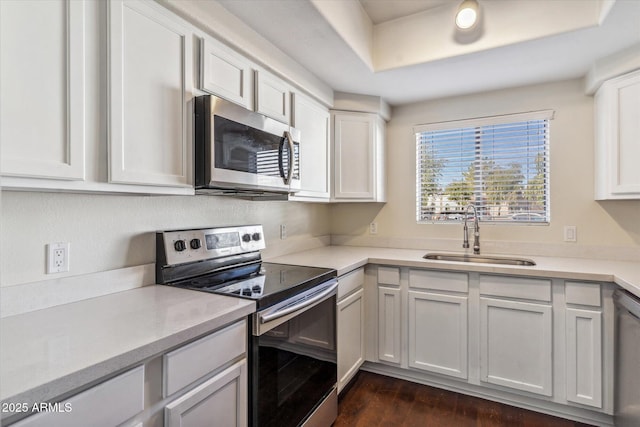 kitchen featuring white cabinetry, sink, stainless steel appliances, and dark hardwood / wood-style floors