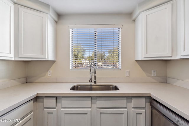 kitchen with white cabinetry, sink, and dishwasher