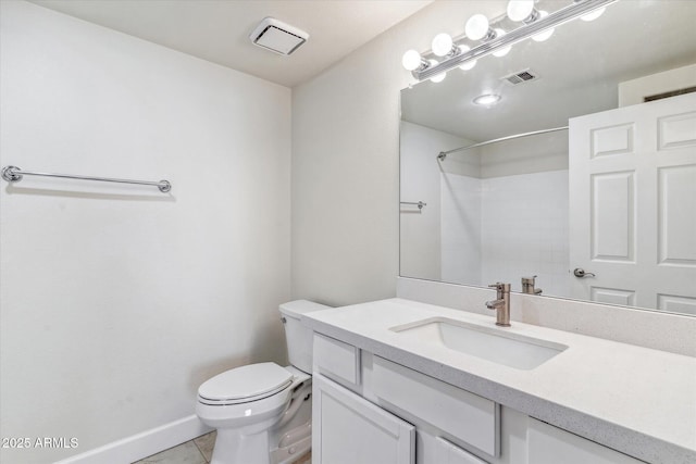 bathroom with vanity, walk in shower, tile patterned floors, and toilet