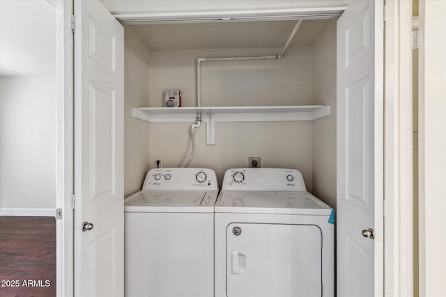 laundry area with dark wood-type flooring and washing machine and dryer