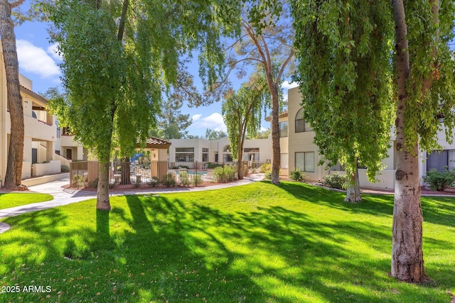 view of home's community with a yard