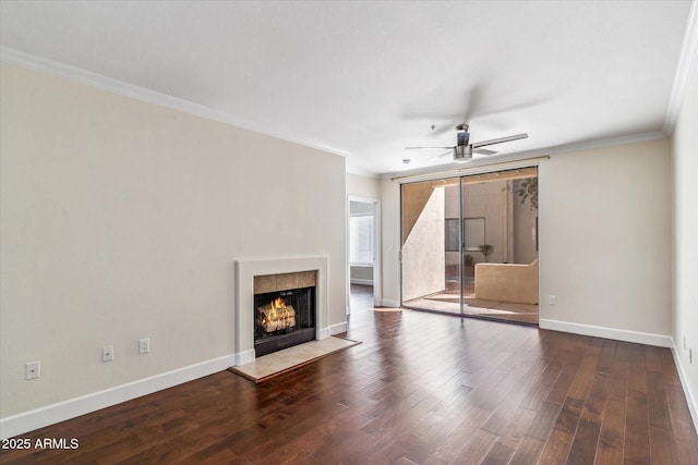 unfurnished living room with crown molding, hardwood / wood-style flooring, a fireplace, and ceiling fan