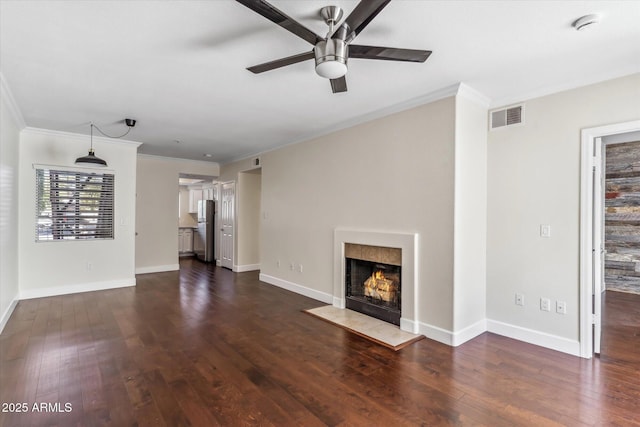 unfurnished living room with dark wood-type flooring, ceiling fan, and crown molding