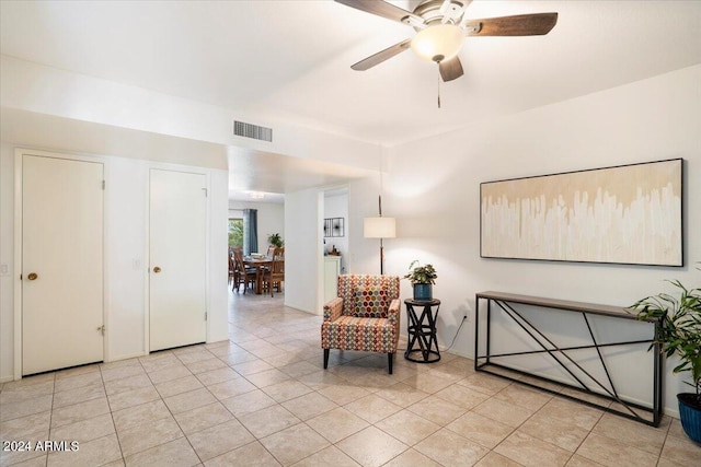 sitting room featuring ceiling fan and light tile patterned floors