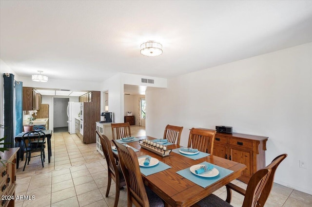 tiled dining area featuring sink