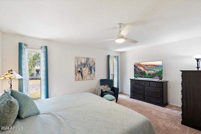 bedroom featuring ceiling fan and light colored carpet