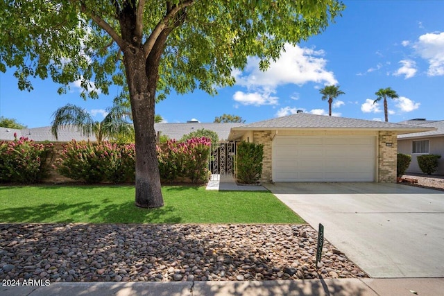 single story home with a front yard and a garage