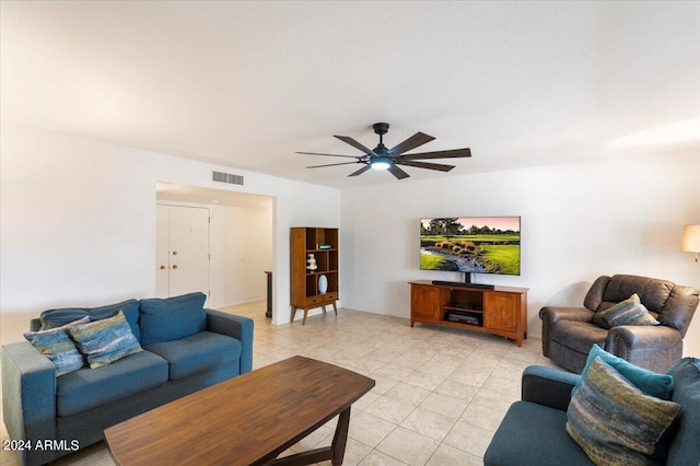 tiled living room featuring ceiling fan