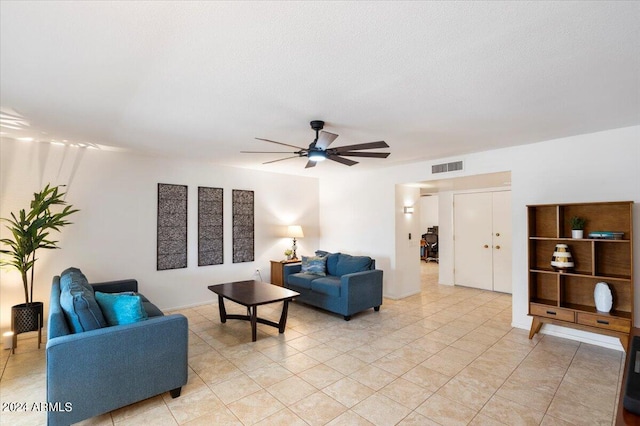 tiled living room with ceiling fan