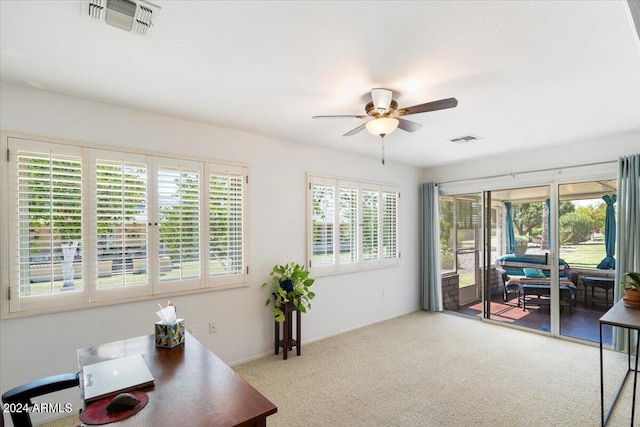 carpeted office space featuring ceiling fan