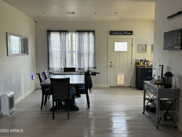 dining room with plenty of natural light and hardwood / wood-style floors