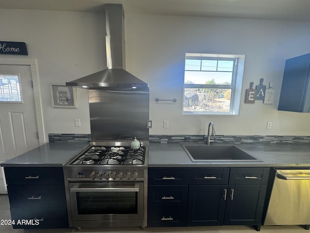 kitchen featuring wall chimney range hood, sink, and appliances with stainless steel finishes