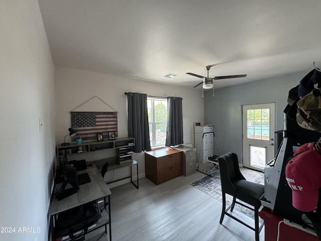 home office with plenty of natural light, light hardwood / wood-style floors, and ceiling fan