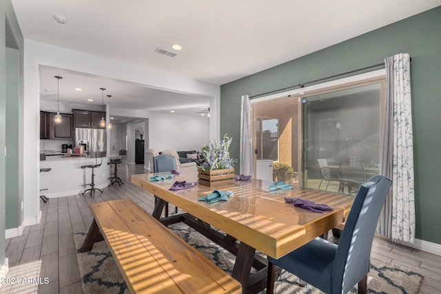 dining space with dark hardwood / wood-style flooring and ceiling fan