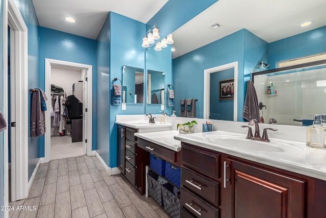 bathroom with hardwood / wood-style floors, vanity, and walk in shower