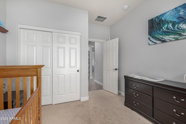 carpeted bedroom with a closet