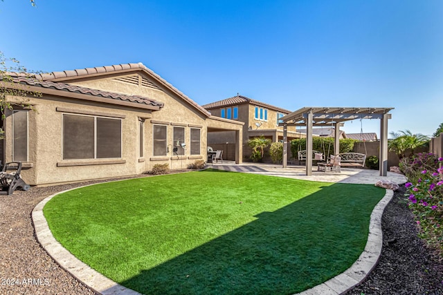 rear view of house featuring a pergola, a patio, and a lawn