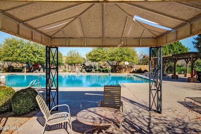 view of swimming pool with a gazebo and a patio