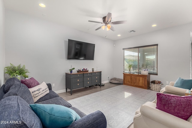 living room with ceiling fan and light hardwood / wood-style flooring