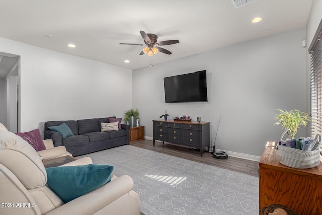 living room featuring ceiling fan and light hardwood / wood-style flooring