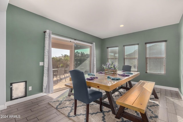 dining space with wood-type flooring