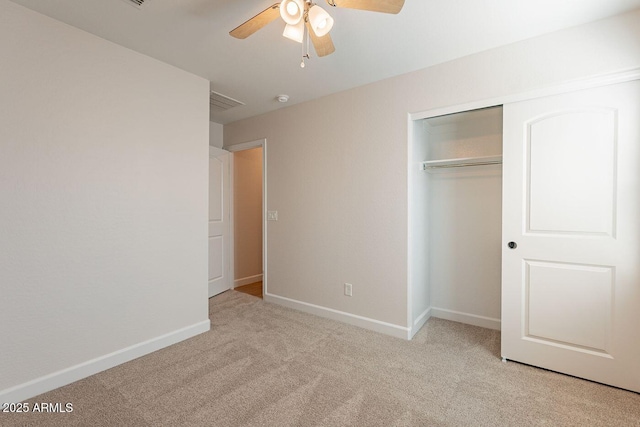 unfurnished bedroom with a closet, ceiling fan, baseboards, and carpet