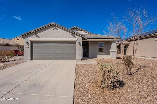 ranch-style home with a tiled roof, stucco siding, an attached garage, and driveway