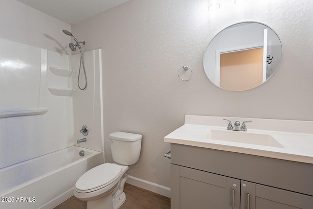 full bathroom with vanity, wood finished floors, baseboards, shower / washtub combination, and toilet