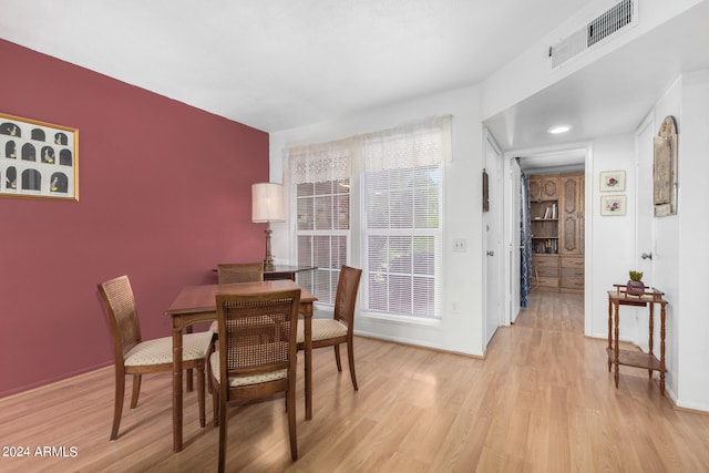 dining area with light hardwood / wood-style flooring and a wealth of natural light