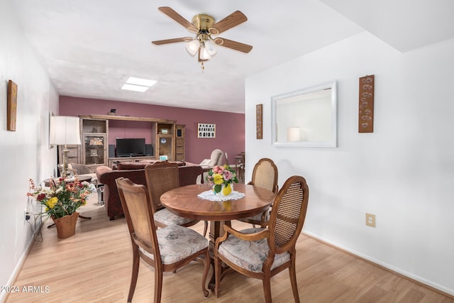 dining room with ceiling fan and light wood-type flooring