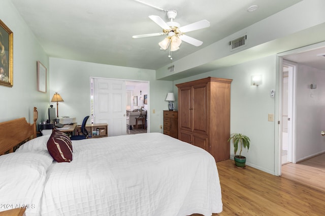 bedroom featuring ceiling fan, a closet, and light hardwood / wood-style floors