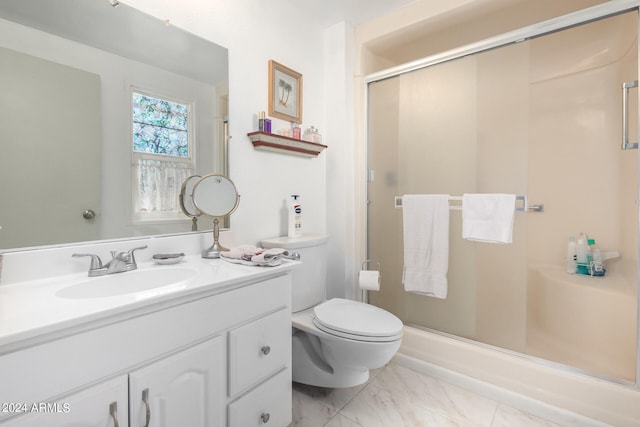 bathroom with a shower with shower door, toilet, and vanity