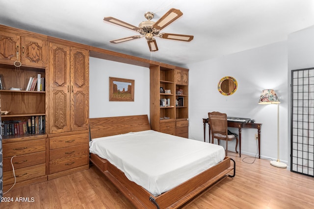 bedroom with ceiling fan and light hardwood / wood-style floors