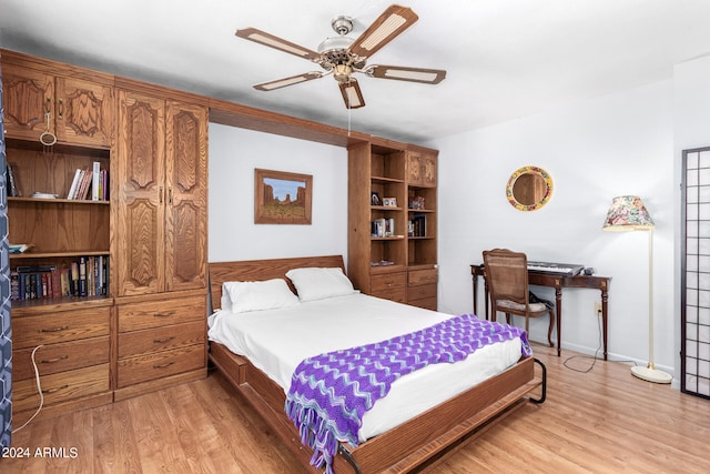 bedroom with wood-type flooring and ceiling fan