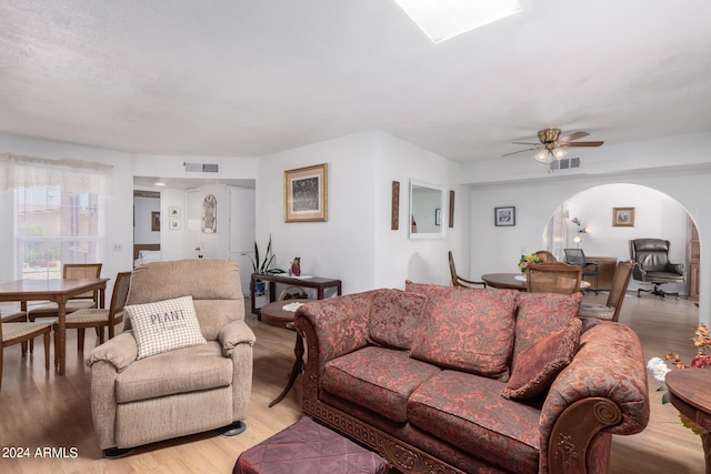 living room featuring ceiling fan and light hardwood / wood-style floors