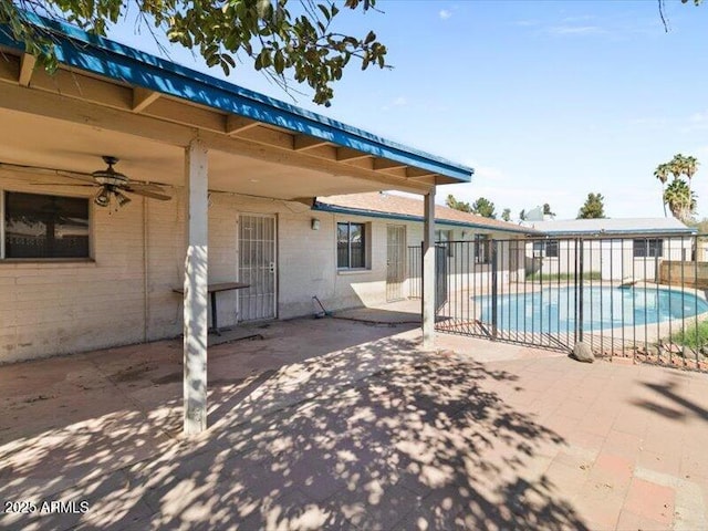 view of pool with a patio, fence, a fenced in pool, and a ceiling fan