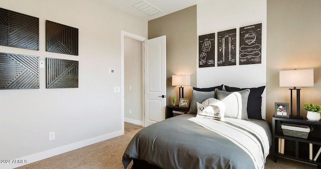 bedroom with carpet flooring, visible vents, and baseboards